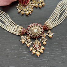 Load image into Gallery viewer, Ornate necklace and earrings with red and gold accents on a dark surface
