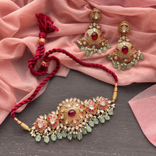 Load image into Gallery viewer, Ornate necklace and earrings on a pink fabric background
